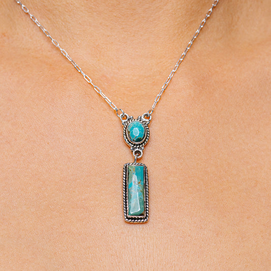 Sterling silver necklace with turquoise pendant in ornate bezel setting