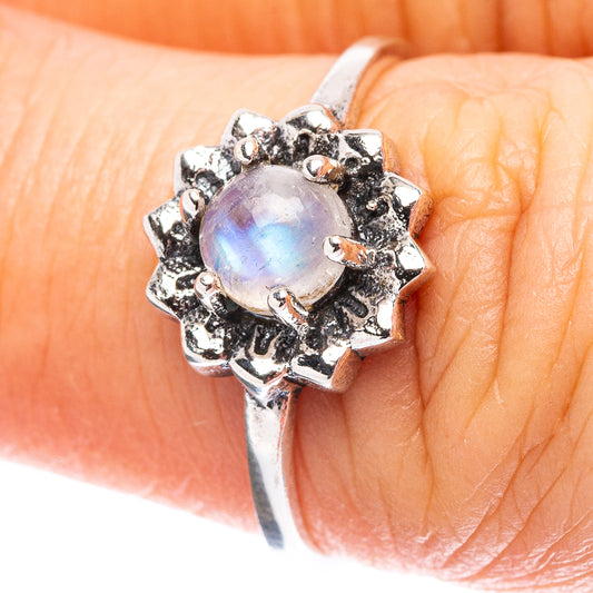 Sterling silver moonstone ring with iridescent round stone and ornate bezel setting
