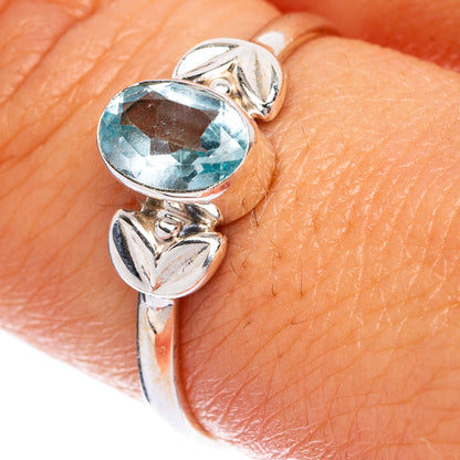 Sterling silver ring with oval blue topaz and leaf-like split shoulders