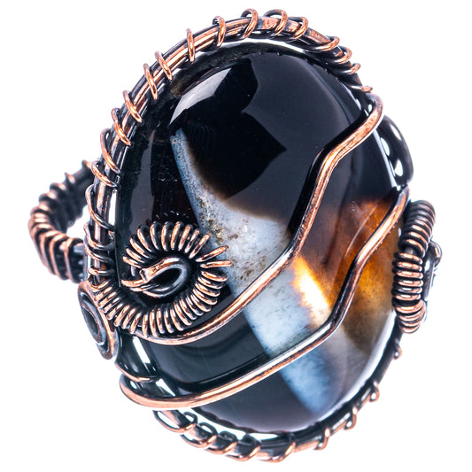 Oxidized copper wire wrap ring with dark banded agate centerpiece and spiral wire details