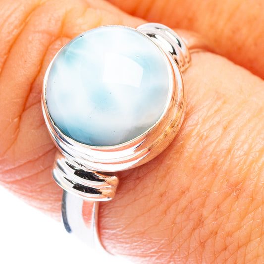 Sterling silver oval light-blue larimar cabochon ring on hand with polished split band