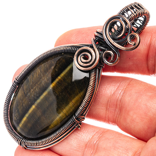 Oxidized copper wire-wrapped tiger's eye pendant with spiral bail detail