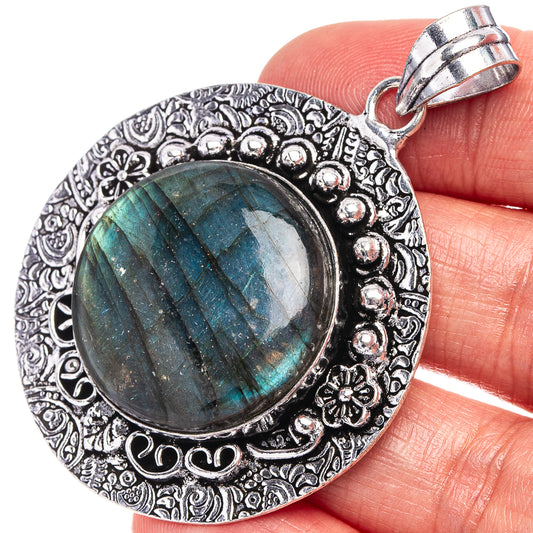 Labradorite oval pendant with ornate German-silver bezel and bail, teal-blue flash