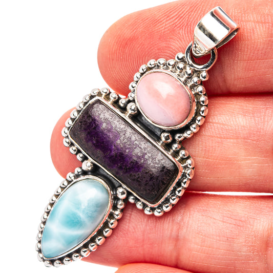 Sterling silver pendant with oval pink opal, purple sugilite, and blue larimar cabochons
