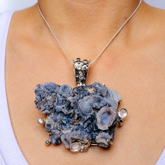 Blue druzy crystal pendant in .925 sterling silver with round halo gemstone settings