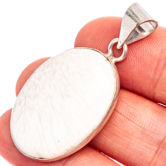Oval scolecite pendant with white stone and silver-plated bail, close-up