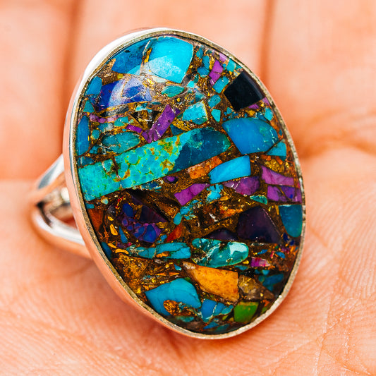 Sterling silver ring with oval turquoise, purple, and gold mosaic inlay, angled view