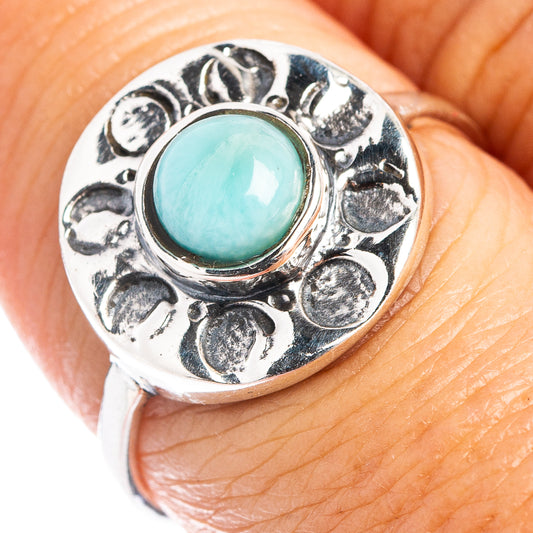 Sterling silver larimar ring with round bezel-set turquoise cabochon and ornate petal details