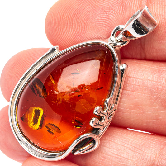 Amber teardrop pendant with .925 sterling silver frame and leaf accents on bail