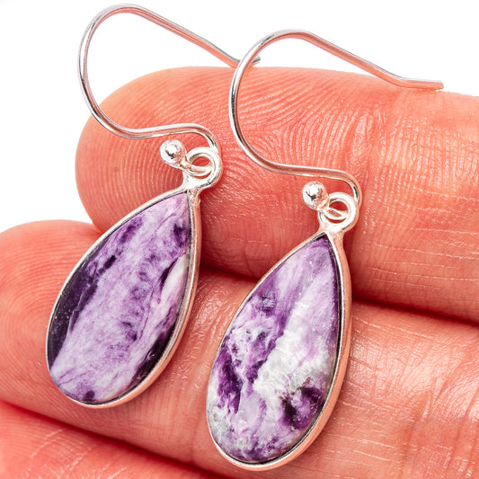 Sterling silver Kammererite drop earrings with purple teardrop stones and wire hooks.
