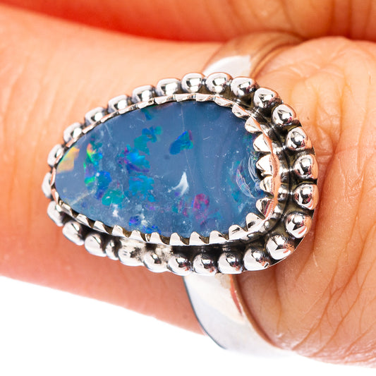 Sterling silver oval opal ring with beaded bezel and blue iridescent stone, size 7.
