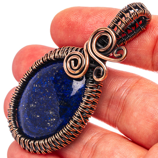 Oxidized copper wire-wrap pendant with blue lapis lazuli teardrop stone and spiral loops