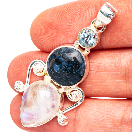 Sterling silver pendant with dark blue round stone and oval crystal, plus blue accents