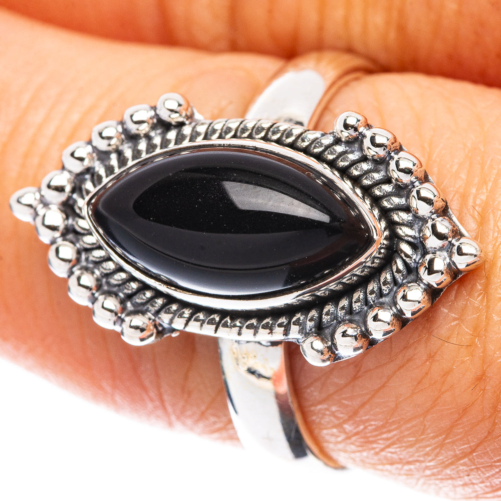 Oval black onyx sterling silver ring with beaded halo border