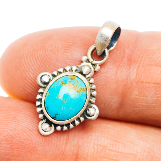 Sterling silver turquoise oval pendant with ornate rope border and small bead accents
