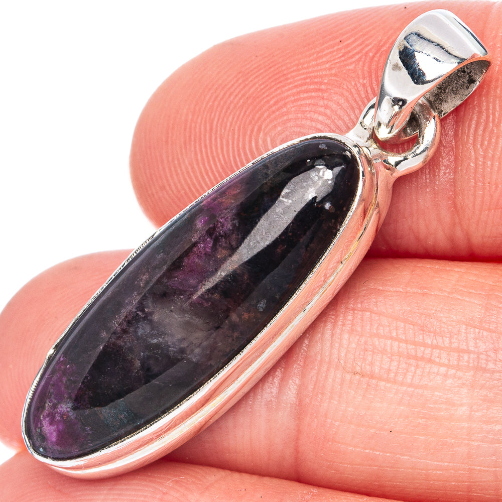 Close-up oval eudialyte pendant with 925 sterling silver bezel, dark purple and violet.