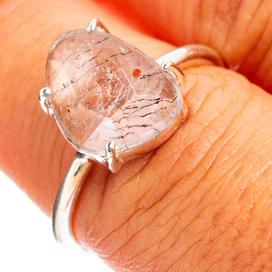 Sterling silver ring with faceted pink stone in heart-shaped bezel setting