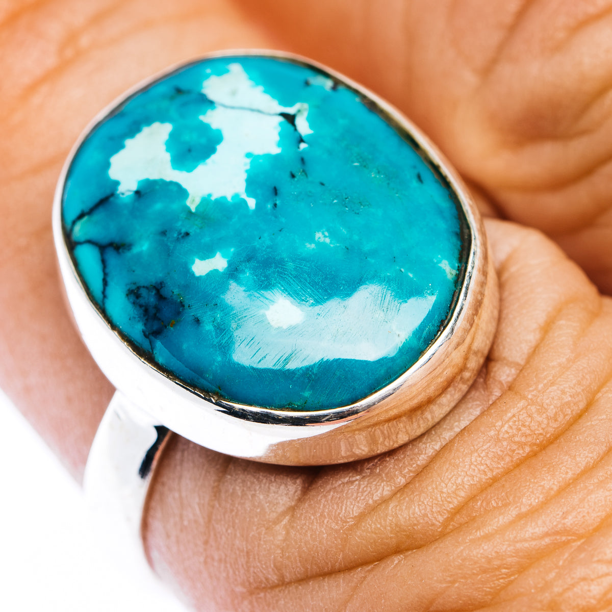 Oval turquoise cabochon sterling silver ring with gold-toned bezel detail