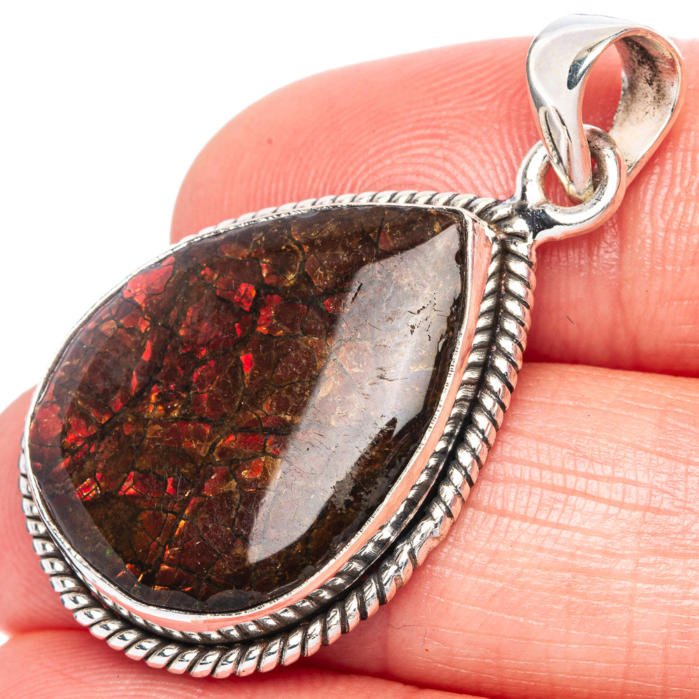 Ammolite teardrop pendant with red iridescent stone and braided sterling silver bezel