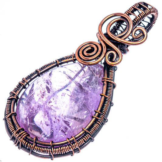 Amethyst teardrop pendant with oxidized copper wire spirals and loop bail