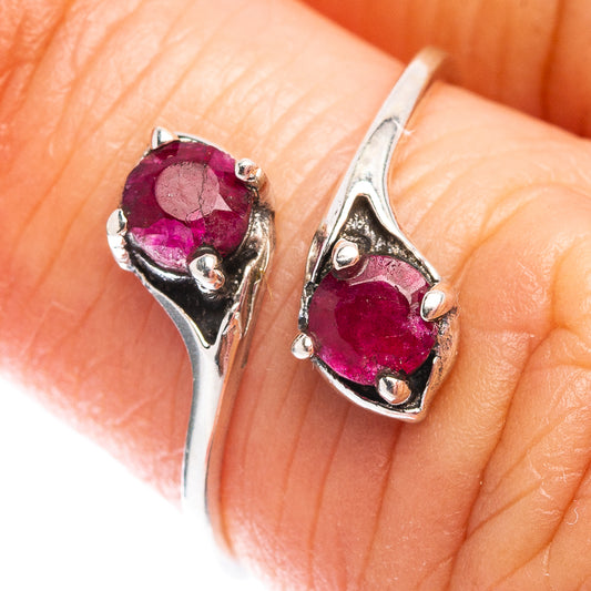 Dainty sterling silver ring with deep red oval gemstone in prong setting