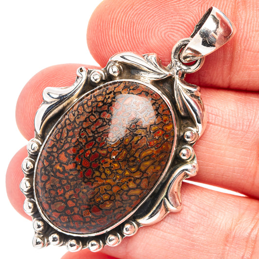 Oval .925 sterling silver dinosaur bone pendant close-up, red-brown speckled fossil face