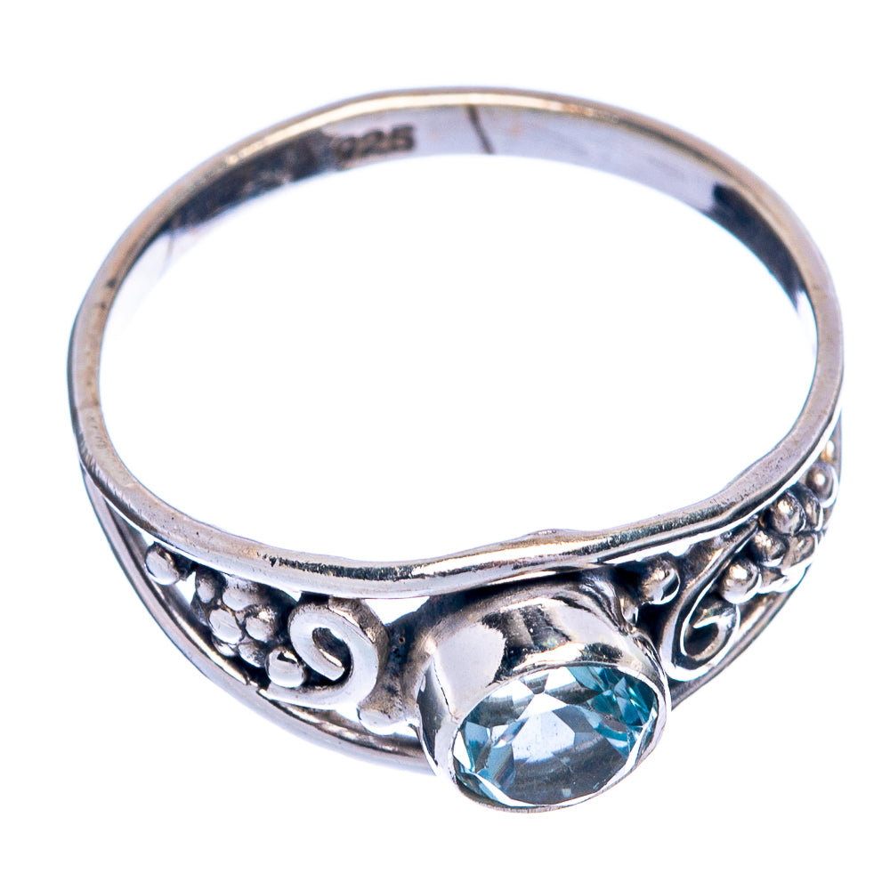 Sterling silver dainty ring with decorative band and round blue topaz gemstone