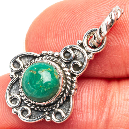 Sterling silver pendant with green cabochon and ornate round bezel on chain link