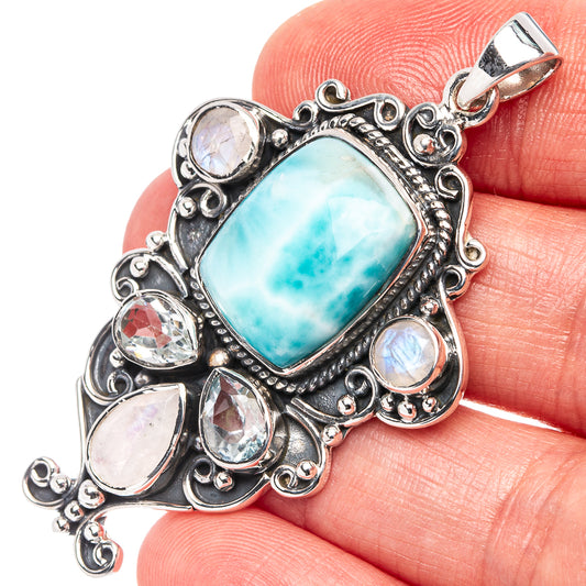 Sterling silver pendant with rectangular turquoise stone and oval opal-like accents