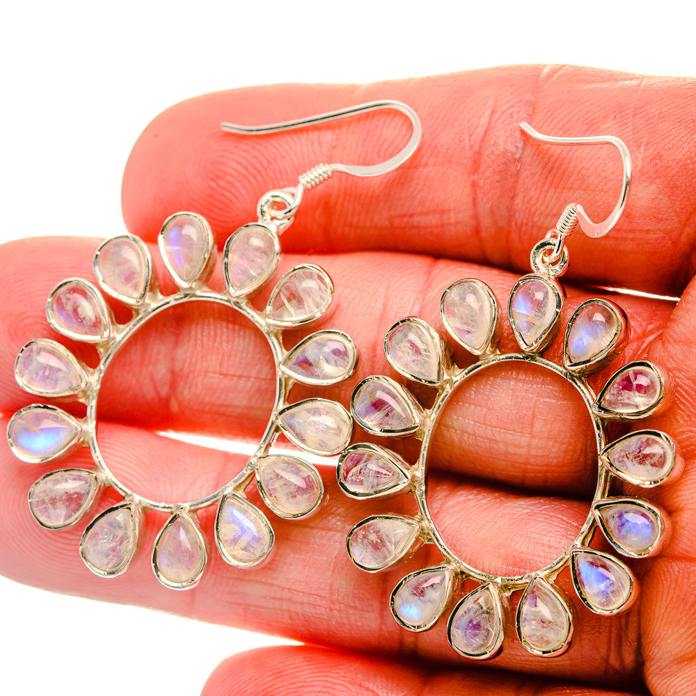 Sterling silver hoop earrings with pear-shaped rainbow moonstone drops, openwork halo