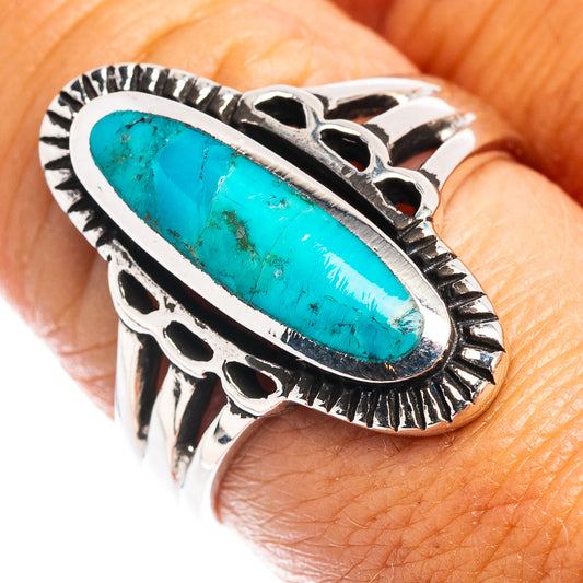 Turquoise oval-stone sterling silver ring with ornate bezel and split shank