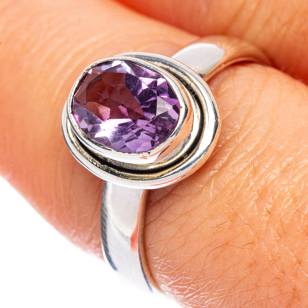 Amethyst gemstone sterling silver ring with faceted purple center, open bezel detail