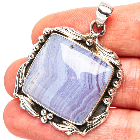 Sterling silver pendant with blue lace agate gemstone, ornate bezel and bail