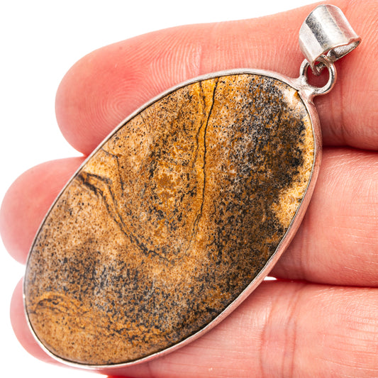 Picture jasper oval pendant on silver-plated bail, speckled earthy orange and dark gray.