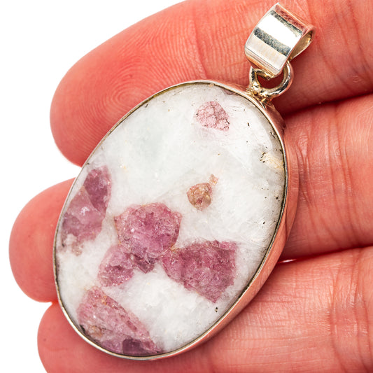Oval tourmaline-in-quartz pendant in pink tones with sterling silver setting.