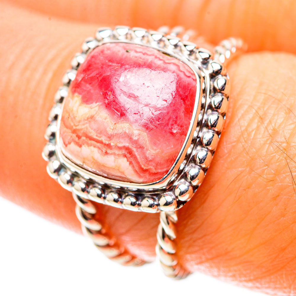 Sterling silver oval red-pink stone ring with textured bead setting on finger