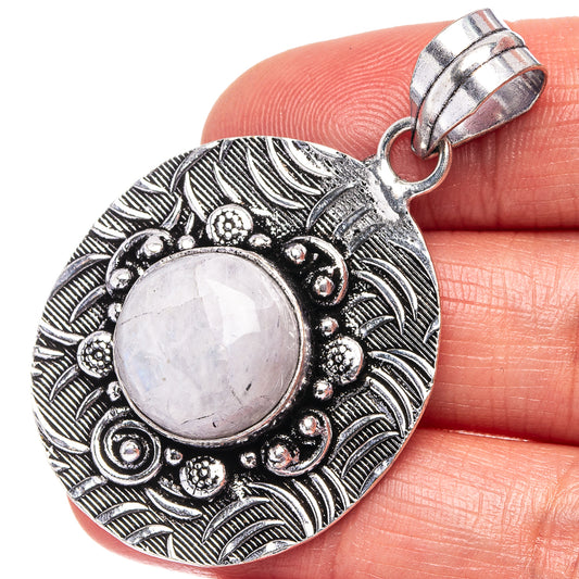 German silver pendant with round rainbow moonstone and ornate leaf filigree bail