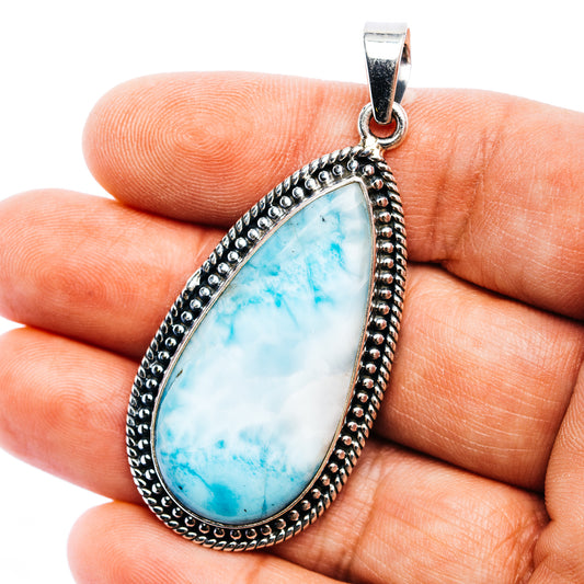 Teardrop larimar pendant with .925 sterling silver bezel and scalloped edge