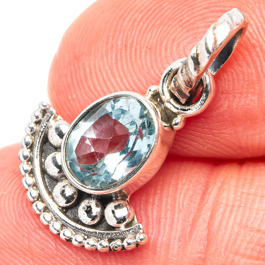 Oval blue topaz pendant in .925 sterling silver, ornate bezel and loop bail