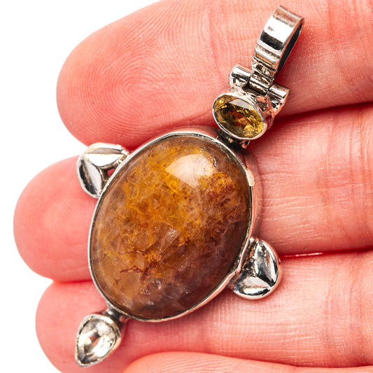 Oval amber sunstone cabochon pendant in .925 sterling silver bezel with side loops
