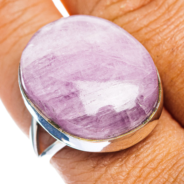 Oval purple kunzite cabochon ring with silver setting and gold-tone rim