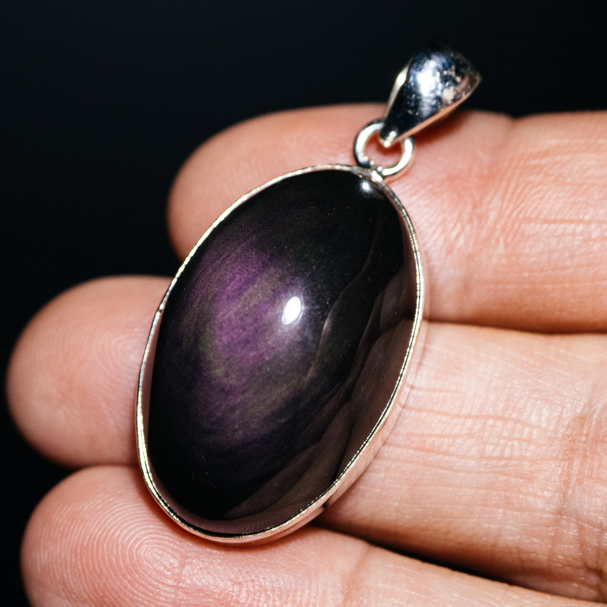 Oval rainbow obsidian pendant with purple sheen and sterling silver setting