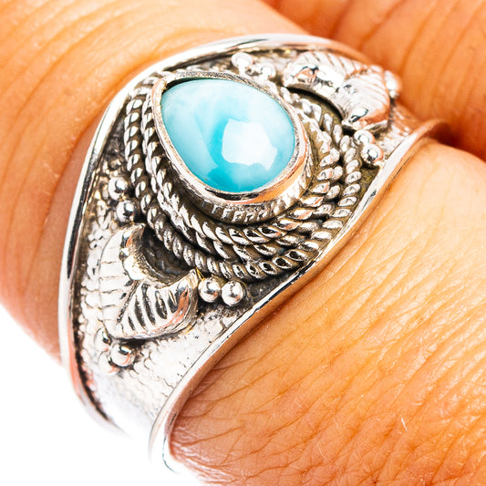 Sterling silver cocktail ring with oval light blue larimar and ornate scrollwork