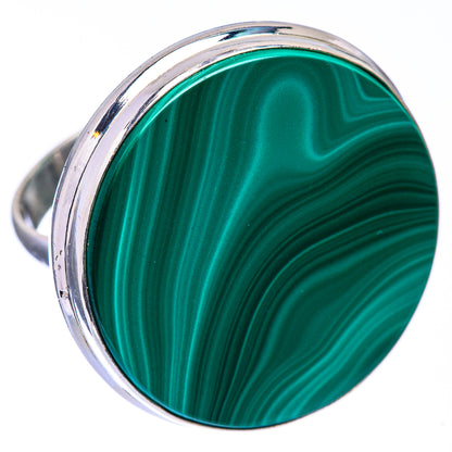 Malachite coin ring showing green swirls in round stone with polished silver bezel