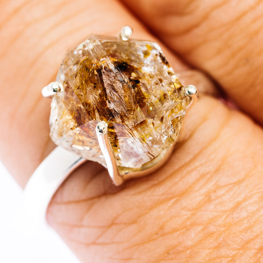 Sterling silver ring with a large faceted quartz stone and brown inclusions