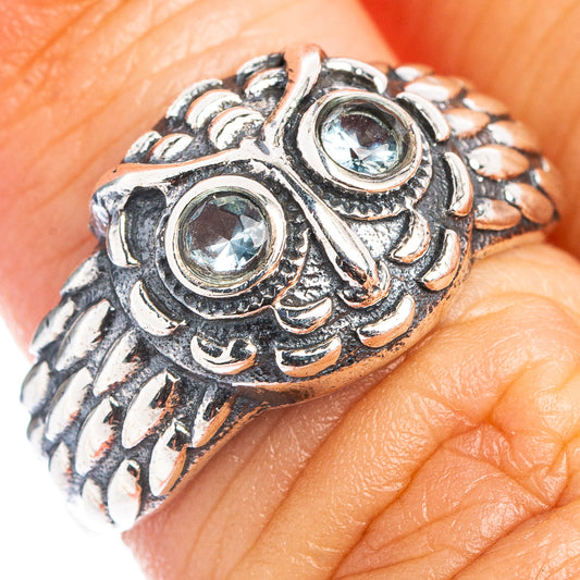 Sterling silver owl dainty ring with two blue topaz-style stones, close-up on band