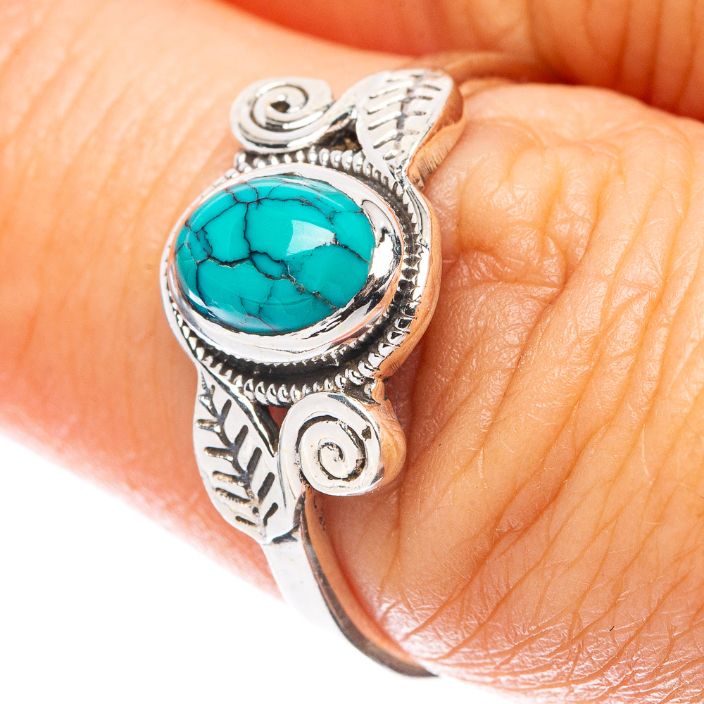 Sterling silver ring with oval turquoise cabochon and leaf filigree detail