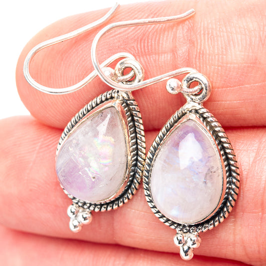 Sterling silver teardrop moonstone drop earrings with bead border and dangling charms