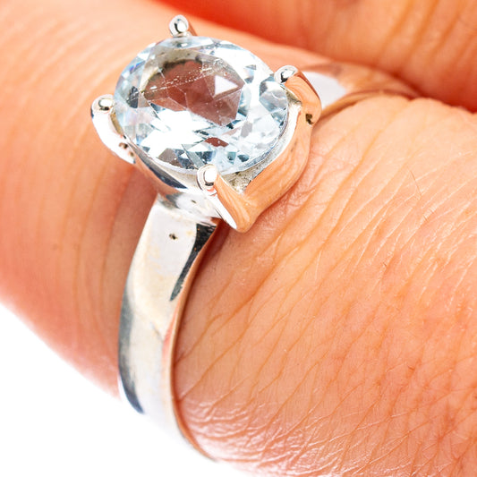 Sterling silver ring with round faceted light blue topaz in four-prong setting