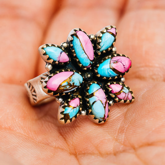 Southwestern flower ring showing turquoise and pink teardrop stones, antiqued dark setting